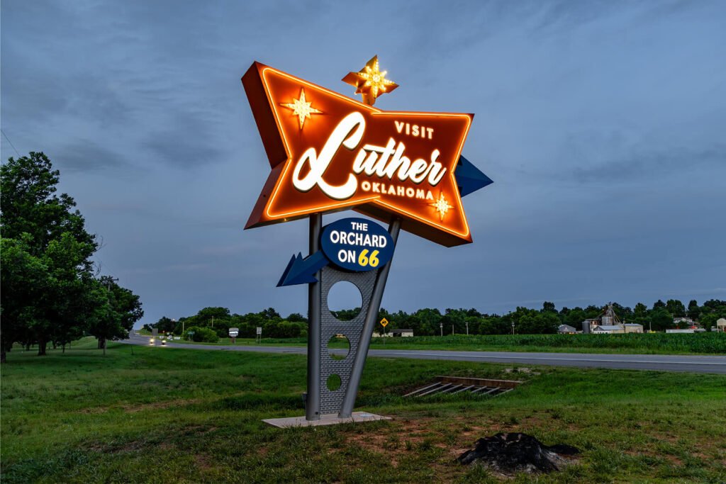 Exterior illuminated push-through acrylic dimensional sign with LED, faux neon, and light bulb styling for the town of Luther, Oklahoma.