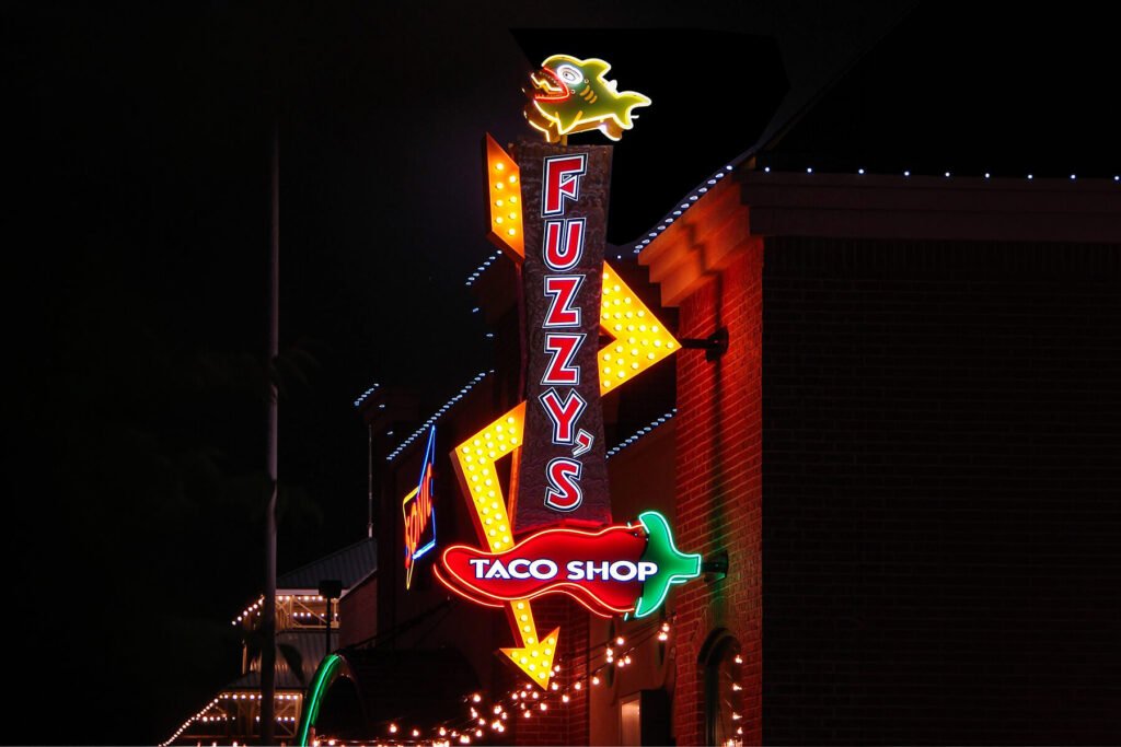 Exterior illuminated channel letters with faux neon, LEDs, and light bulbs for Fuzzy's Taco Shop restaurant.