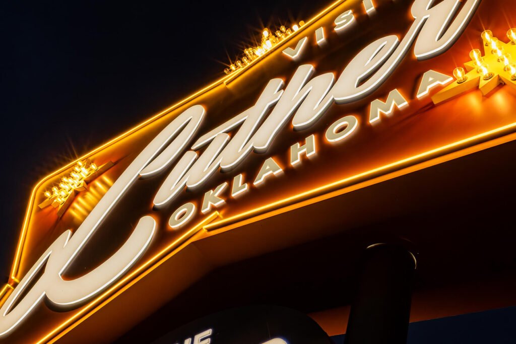 Close-up view of an exterior illuminated faux neon routed push-through acrylic dimensional sign for the town of Luther, Oklahoma.