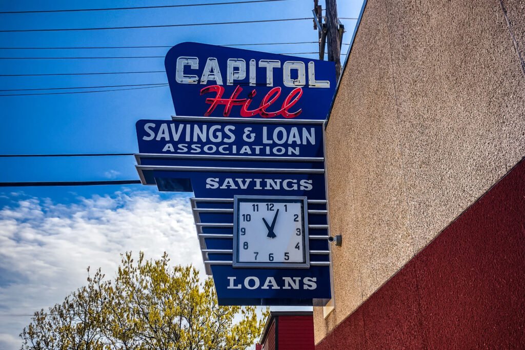 Exterior illuminated cabinet sign featuring real and faux neon elements for Capitol Hill Bank.