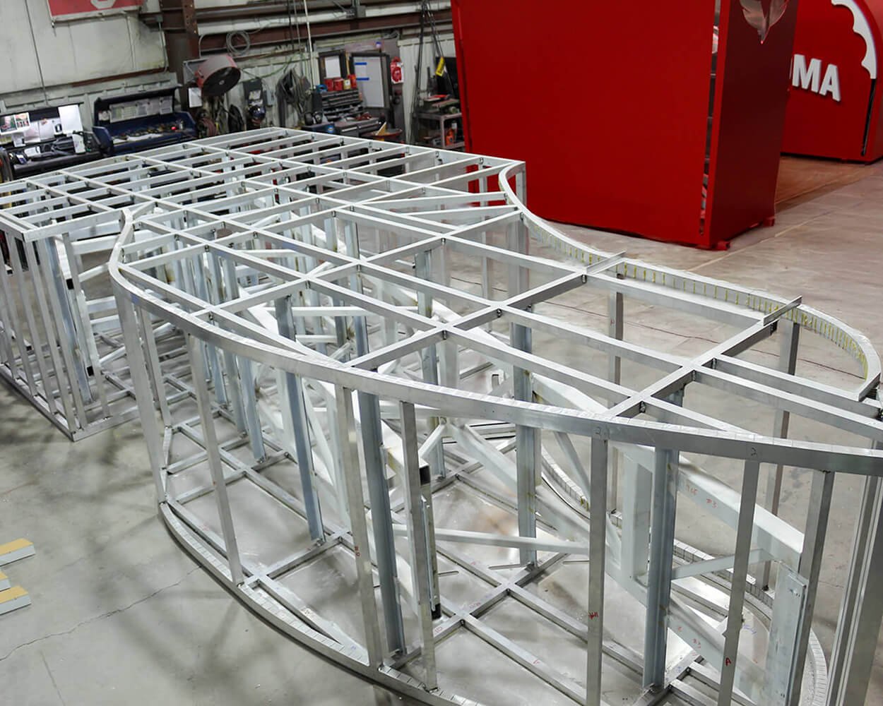 Fabrication of aluminum and steel framework for the bottom of the Kicks 66 Boot with the completed top two sections in the background.