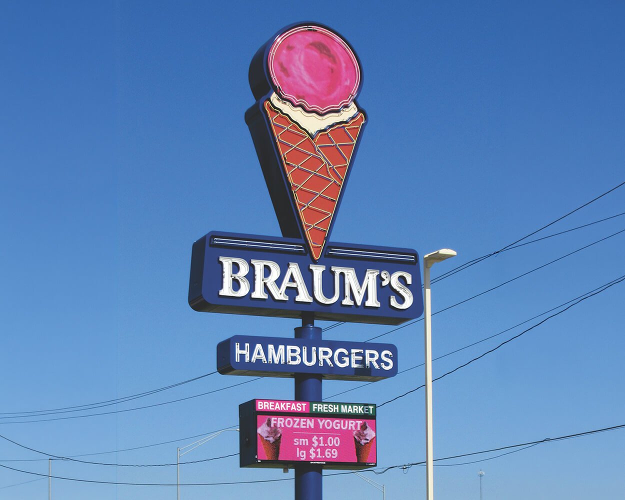 Maintenance and repair of a Braum's restaurant food chain store exterior sign.